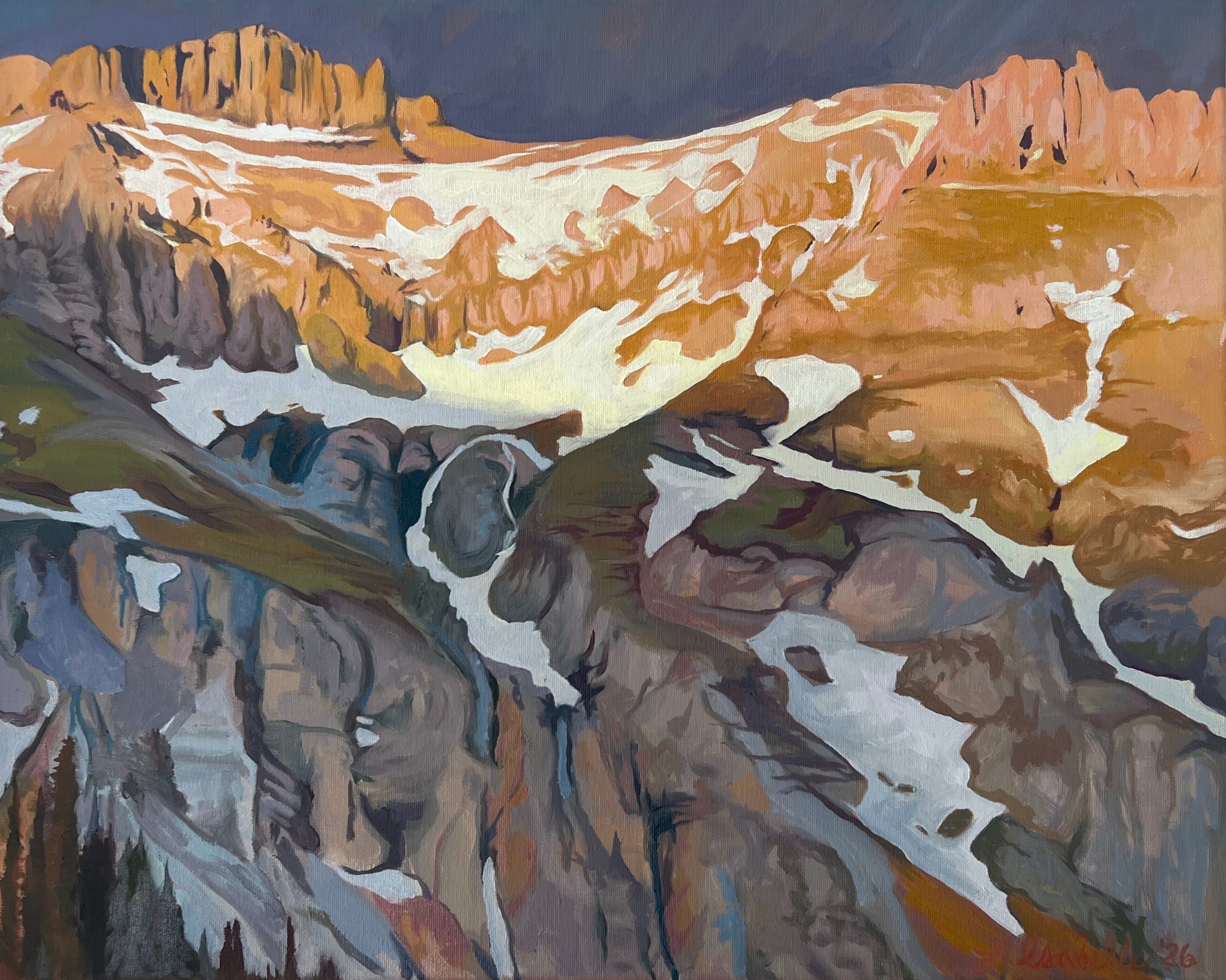 Low sun striking the orange rock and snow along the top of a high ridge while the grey cliffs beneath it stay in shadow, under a deep blue-grey sky.